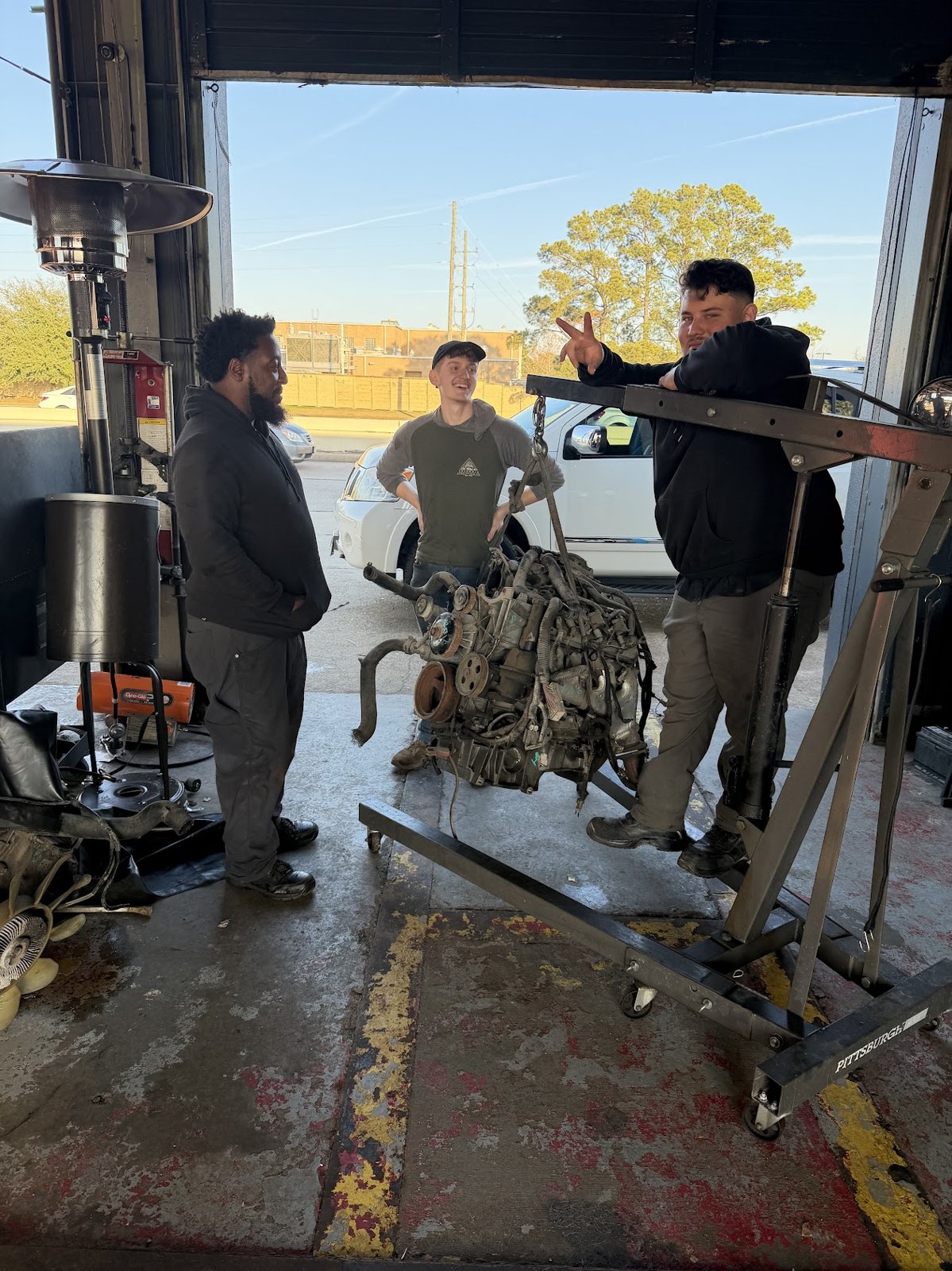 The Car Time Automotive crew working on an engine